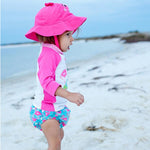 KIT MARE NEONATO COSTUMINO CONTENITIVO + CAPPELLINO, FENICOTTERO - SPF50+